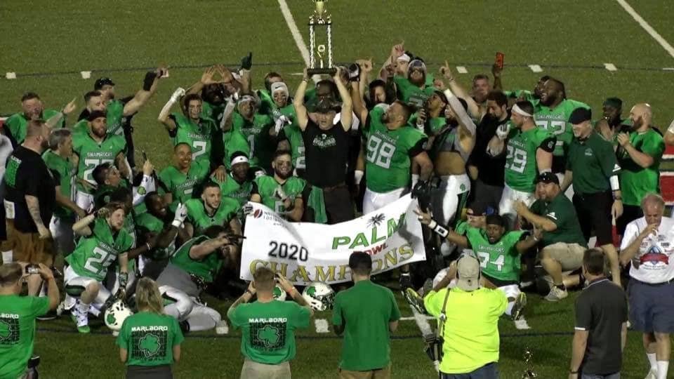 NEFL champions hoisting championship trophy